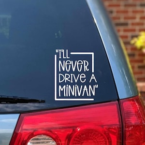 May include: A white vinyl decal with the text "I'll Never Drive A Minivan" in a square frame, applied to the back window of a red car.