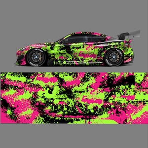 May include: A black car with a pink and green camouflage wrap. The wrap has a splatter paint design.