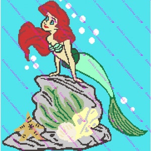 May include: A pixelated image of Ariel, the Little Mermaid, standing on a rock with her tail in the water. She has long red hair and is wearing a green seashell bra. A small orange cat is sleeping on the rock below her.