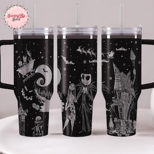 A set of three black tumblers with Halloween-themed designs printed on them.