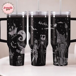 A set of three black tumblers with Halloween-themed designs printed on them.