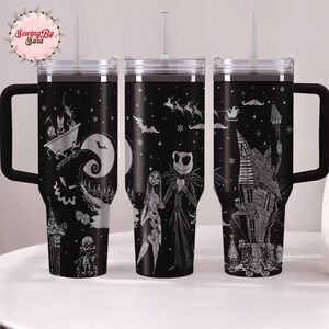 A set of three black tumblers with Halloween-themed designs printed on them.