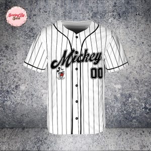 A white baseball jersey with black stripes, featuring the name "Mickey" and the number "00" printed on it.