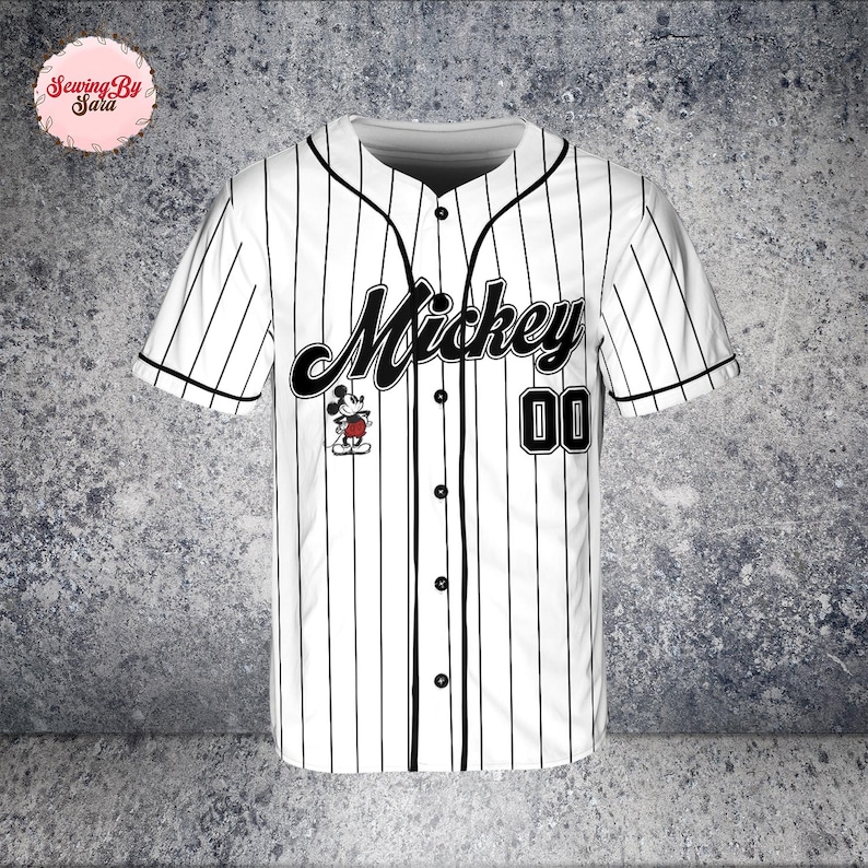 A white baseball jersey with black stripes, featuring the name "Mickey" and the number "00" printed on it.