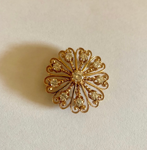 Yellow gold and diamond broach, necklace or pin.