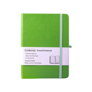 May include: A green Corderona dotted notebook with a leatherette hardcover. The notebook has 160 pages and opens flat 180 degrees. The B6 size notebook is 13.8 x 18.6cm and features a matching elastic band closure.