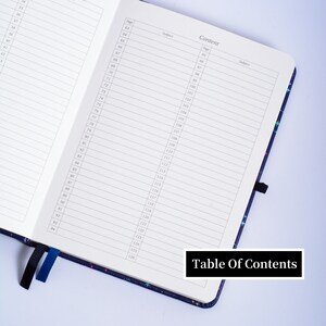 May include: A black and blue notebook with a table of contents page. The page is numbered from 63 to 126. The notebook has a colorful star pattern on the cover.