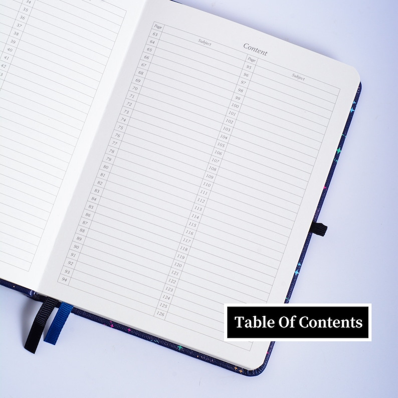 May include: A black and blue notebook with a table of contents page. The page is numbered from 63 to 126. The notebook has a colorful star pattern on the cover.