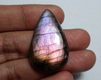 May include: A teardrop-shaped labradorite gemstone with iridescent purple and black hues.