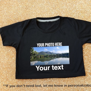 May include: Black cropped t-shirt with a photo of a lake and mountains. The text "YOUR PHOTO HERE" and "Your text" is printed on the shirt. **If you don't need text, let me know in personalization box**