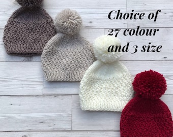 May include: Four knitted hats with pom-poms in different colours: brown, beige, white, and red. Choice of 27 colour and 3 size.