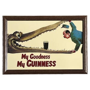 May include: A vintage framed print of a cartoon alligator with a glass of Guinness beer in its mouth. The text "My Goodness My GUINNESS" is printed below the alligator.