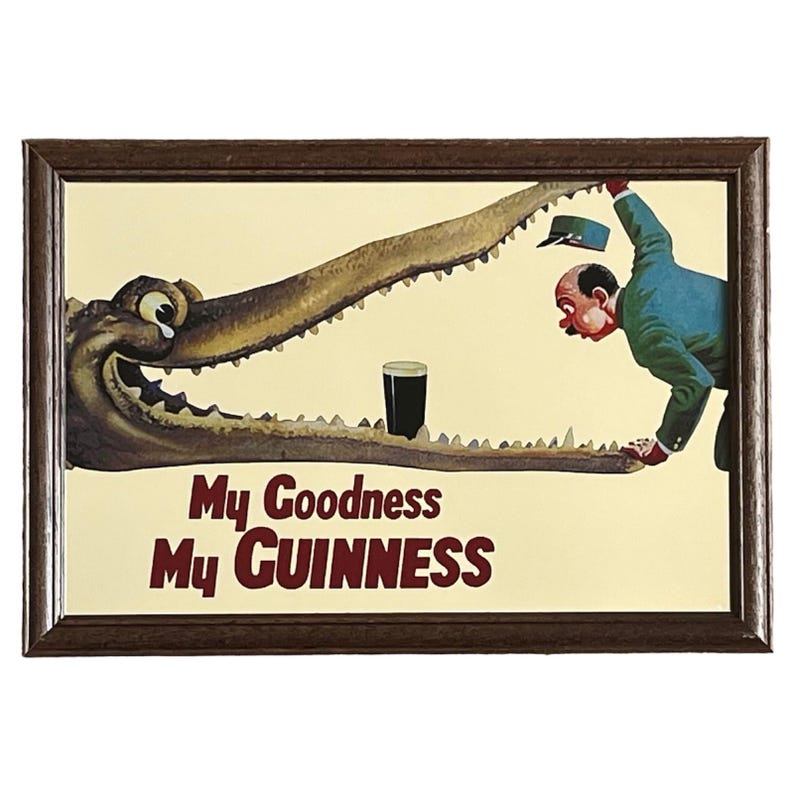 May include: A vintage framed print of a cartoon alligator with a glass of Guinness beer in its mouth. The text "My Goodness My GUINNESS" is printed below the alligator.
