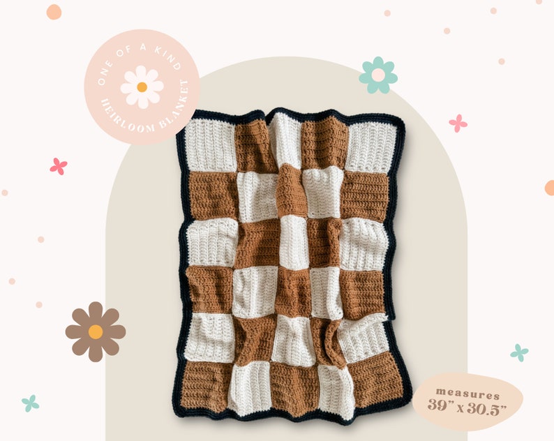 May include: A handmade, checkerboard-patterned blanket in shades of brown and white, with a dark blue border. The blanket measures 39 inches by 30.5 inches. The text on the image reads "ONE OF A KIND HEIRLOOM BLANKET."