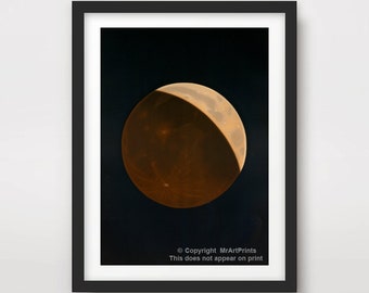 May include: A close-up photograph of a crescent moon in a dark sky. The moon is a pale orange color with a dark shadow covering most of the surface.