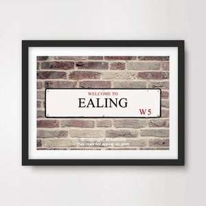 May include: Framed print of a street sign saying "WELCOME TO EALING" in black text, with "EALING" in a larger font size. The sign also has "W5" in red. The background is a brick wall.