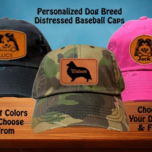 May include: Three distressed baseball caps with personalized dog breed patches. The caps are black, camouflage, and pink. The patches feature a Sheltie dog breed with the names Lucy, Watson, and Jack.
