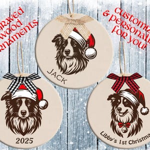 May include: Engraved wood ornaments featuring dog portraits wearing Santa hats. Each ornament is personalized with a name, year, or message. The ornaments have a beige background and are adorned with decorative bows.