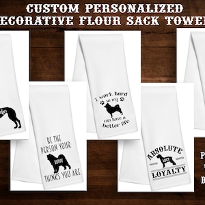 May include: Twelve different designs of white flour sack towels with black dog silhouettes and text. The towels are personalized with a dog's name.  The text on the towels includes "Tucker", "Be the person your dog thinks you are", "I work hard so my dog can have a better life", "Life is good with a dog", and "Absolute loyalty".