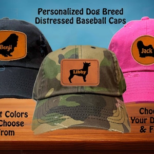 May include: Three personalised distressed baseball caps featuring different dog breeds and names. The caps are in black, camouflage, and pink. The text on the caps reads "Benji", "Libby", and "Jack".