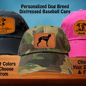 May include: Three distressed baseball caps with personalized dog breed patches. The caps are in black, camouflage, and pink. The patches feature a black silhouette of a dog with the names "Lucy", "Watson", and "Jack" on each patch.