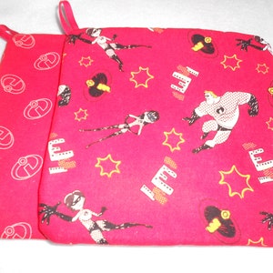 May include: Red fabric pot holder with a white outline of the letter E and a pattern of cartoon characters from the movie Incredibles. The characters include Mr. Incredible, Elastigirl, and Syndrome.