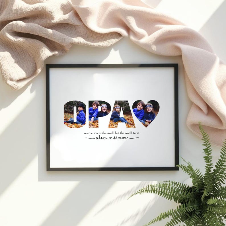Puede incluir: Una impresi&oacute;n enmarcada con la palabra "OPA" en letras grandes, cada letra llena con una foto de ni&ntilde;os. La palabra "OPA" es negra, con un coraz&oacute;n que reemplaza la letra "A". Debajo est&aacute; el texto "one person to the world but the world to us".