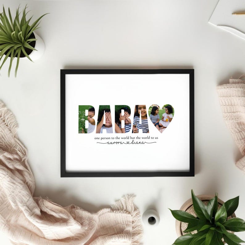 May include: A framed print with the word "BABAS" in green and photo collage letters. The heart-shaped letter features two girls. The text below reads "one person to the world but the world to us" and "aurora & diana".