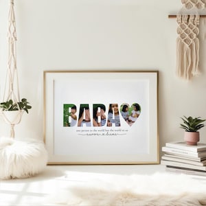 May include: A framed print with the word "BABAS" in large letters, each letter filled with a different photo. The last letter is a heart shape. Below the word is the text "one person to the world but the world to us" and "aurora & diana".