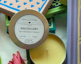 May include: A soy and beeswax candle in a silver tin, labeled "Willoughby" with the text "Book Boyfriend." The candle is surrounded by books with titles like "Sense and Sensibility" by Jane Austen. The candle is 4oz/125g and has a 15-hour burn time.