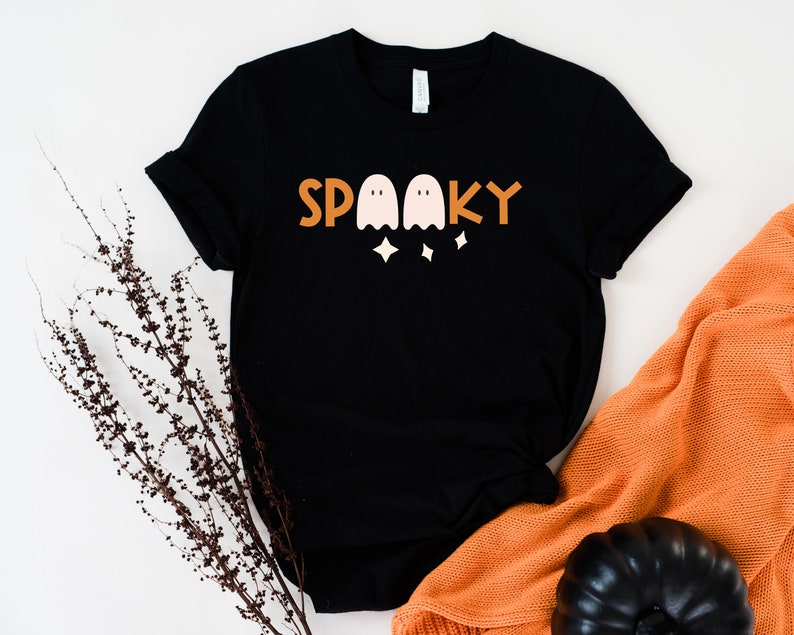 May include: Black t-shirt with a graphic of three ghosts and the word "SPOOKY" in orange and white.