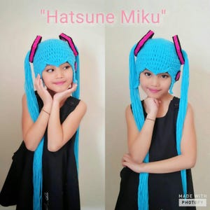 May include: A child wearing a blue and pink crocheted hat with long blue yarn tails. The hat is styled like the character Hatsune Miku. The text "Hatsune Miku" is written above the image.
