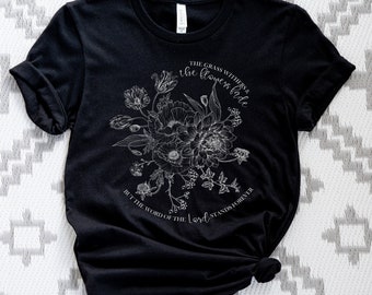 May include: Black t-shirt with a white floral design and the text "THE GRASS WITHERS & the flowers fade BUT THE WORD OF THE Lord STANDS FOREVER".