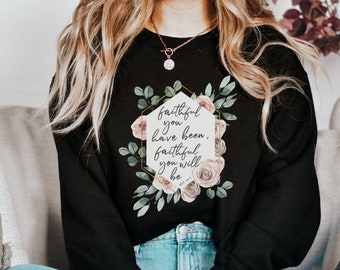 May include: Black sweatshirt with a floral design and the text "faithful you have been, faithful you will be" in a gold hexagon.
