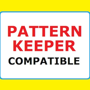 May include: A white sign with a blue border, the words "PATTERN KEEPER COMPATIBLE" in red and black letters.