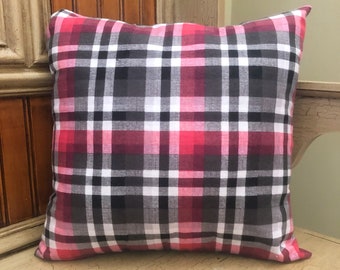 May include: Square pillow with a red, black, white, and gray plaid pattern. The pillow is a decorative item, likely for a bed or sofa. The plaid design is a classic and versatile pattern.
