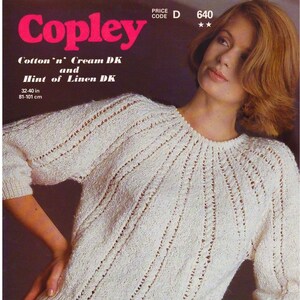 May include: A white knitted sweater with a delicate openwork pattern. The sweater is made with Cotton'n' Cream DK and Hint of Linen DK yarn. The sweater is 32-40 inches in length.