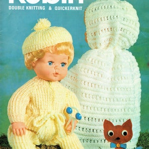 May include: A vintage knitting pattern booklet for a doll's outfit. The cover features a doll wearing a yellow knitted outfit and a white knitted hat. The doll is holding a blue rattle. The booklet is titled "Robin" and has the number "2717" printed on the cover.