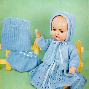 May include: A knitting pattern for a baby doll outfit. The pattern includes instructions for a blue knitted dress, cardigan, bonnet, and diaper. The pattern is from Lee Target and is number 6408. The pattern requires 6 ounces of yarn.