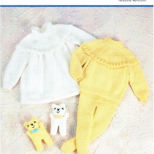 May include: A white knitted baby sweater with a ruffled collar and a yellow knitted baby sweater with a ruffled collar and matching pants. Two knitted teddy bears are also included in the image.