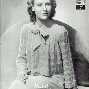May include: A black and white photo of a woman wearing a knitted sweater with a bow. The sweater is made with a lacy stitch pattern. The text "Hand Knitwear in Lavenda" is printed at the bottom of the image. The image is from a vintage knitting pattern book.