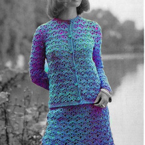 May include: A crochet cardigan and skirt set in a blue and purple color scheme. The set features a button-up cardigan with long sleeves and a matching skirt.