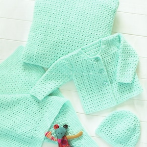 May include: A crochet baby set in a light green color, including a cardigan, a hat, a pillow, and a blanket. The set is laid out on a white wooden surface. The pattern is a simple stitch with a small hole in each stitch. The set is labeled "Wondersoft Crochet 8570 31-56cm 12-22in DK".
