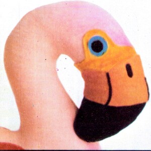 May include: Pink flamingo head plush toy with a black beak and orange and blue eyes.