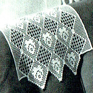 May include: White crocheted chair back cover with a geometric pattern. The cover has a scalloped edge.