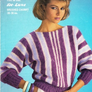 May include: A purple and white striped sweater with a boat neck. The sweater is made of brushed chunky yarn and is available in sizes 30-38 inches.
