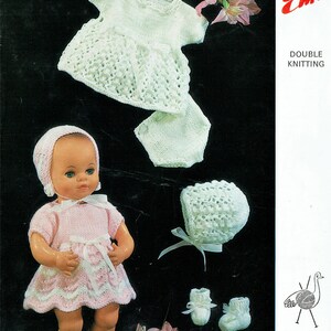 May include: A knitting pattern for a baby doll outfit, including a dress, bonnet, pants, and booties. The pattern is from Emu Double Knitting and is number 6450. The pattern is 7 1/2 pence.