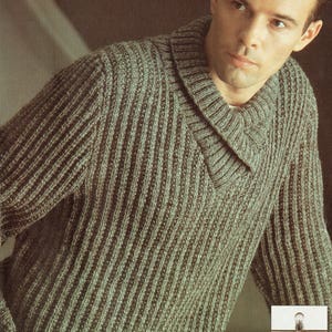 May include: A green ribbed knit sweater with a wide, folded collar. The sweater is made with a soft, textured yarn.