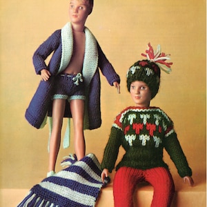 May include: A vintage knitting pattern cover featuring two dolls dressed in knitted outfits. One doll wears a blue robe and shorts, the other a green sweater, red pants, and a hat. A striped scarf is also included. The text reads "PATONS double knittings & 4-ply".