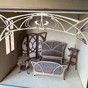May include: A miniature dollhouse room with a wooden bed, two side tables, a screen, and a decorative archway. The room is made of wood and has a light brown finish.